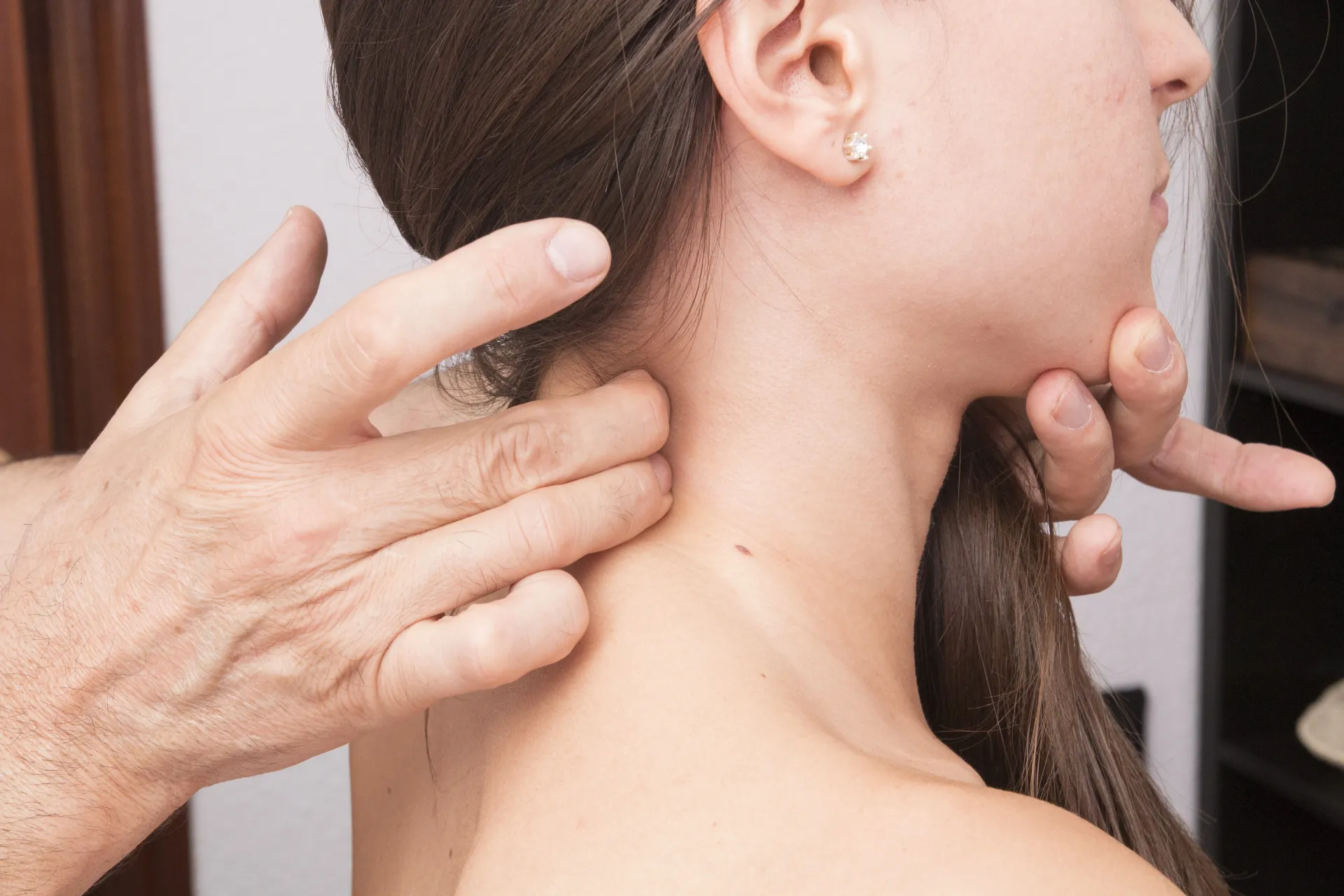 doctor aligning woman's neck to indicate cervical fracture